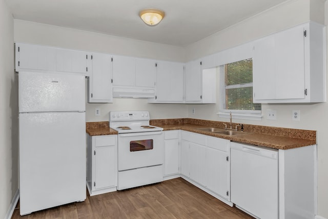 kitchen with sink, white cabinets, and white appliances