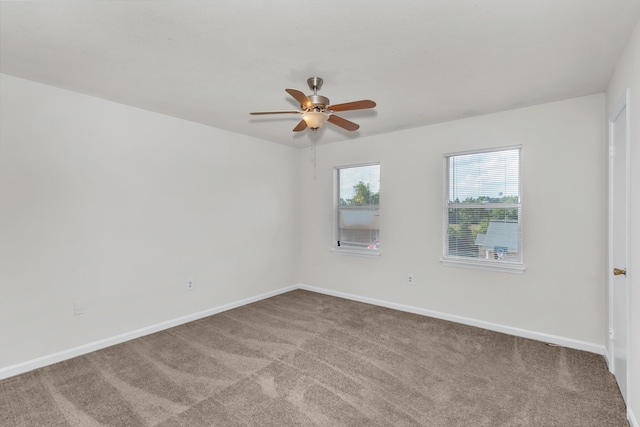 carpeted spare room with ceiling fan