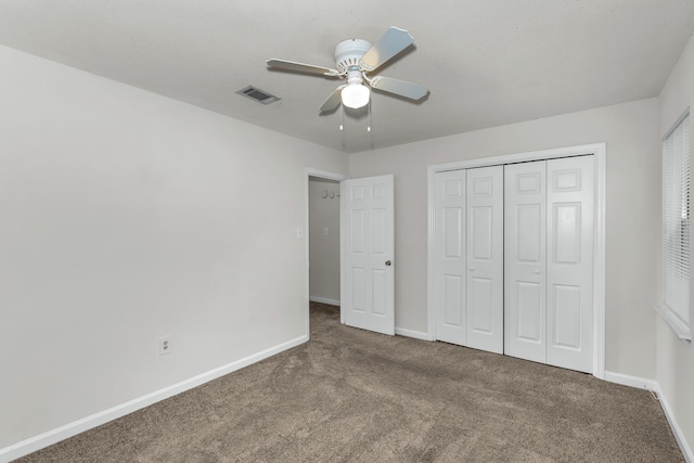 unfurnished bedroom featuring ceiling fan, carpet floors, and a closet