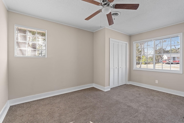 unfurnished bedroom featuring a closet, carpet flooring, crown molding, and visible vents