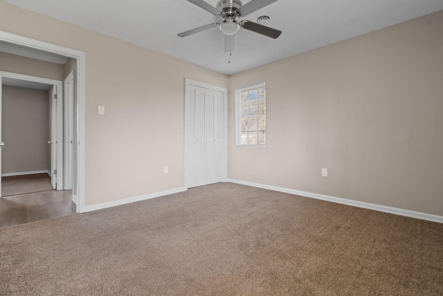 unfurnished bedroom featuring ceiling fan, carpet floors, a closet, and baseboards