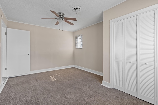 unfurnished bedroom featuring carpet floors, ornamental molding, a closet, and visible vents