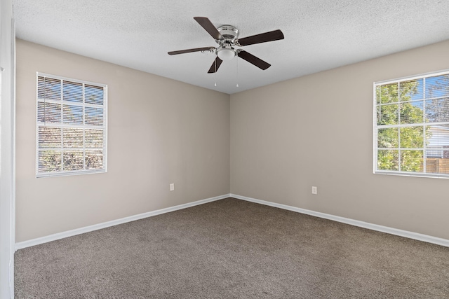 carpeted empty room featuring a ceiling fan, baseboards, and a textured ceiling