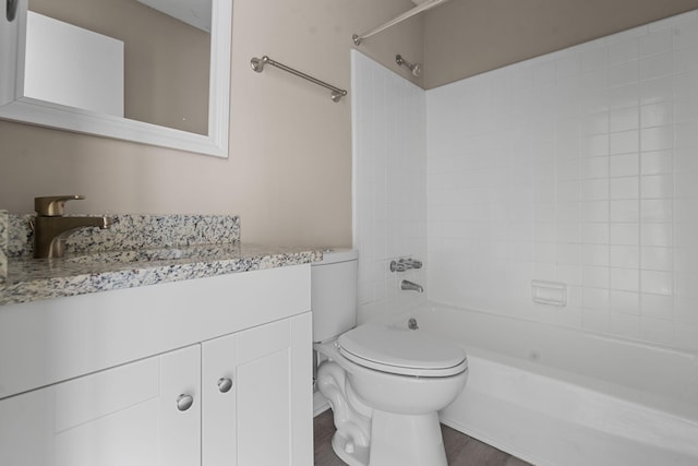 bathroom with toilet, vanity, and bathing tub / shower combination