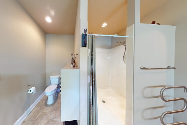 bathroom featuring a shower, tile patterned floors, and toilet