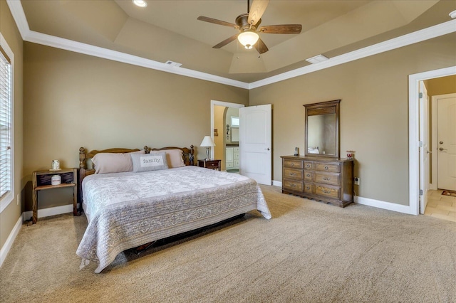 carpeted bedroom featuring crown molding, a tray ceiling, multiple windows, and ceiling fan