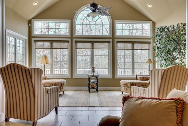 sunroom / solarium featuring vaulted ceiling, a healthy amount of sunlight, and ceiling fan