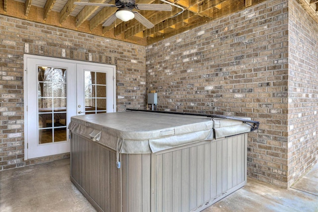 view of patio / terrace featuring french doors, ceiling fan, and an indoor hot tub