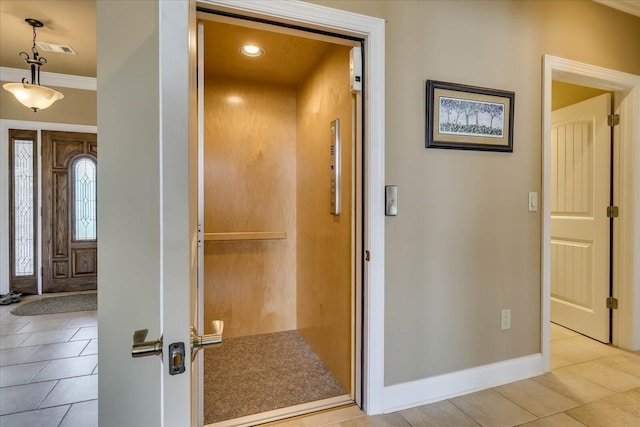 interior space featuring elevator and light tile patterned flooring