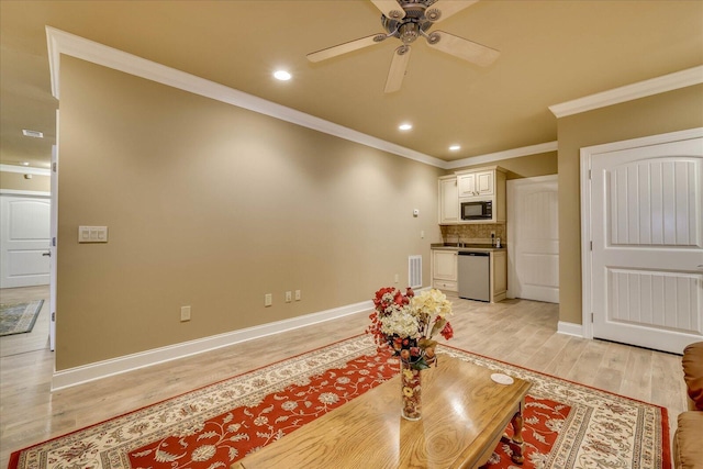 living room with ornamental molding, ceiling fan, and light wood-type flooring