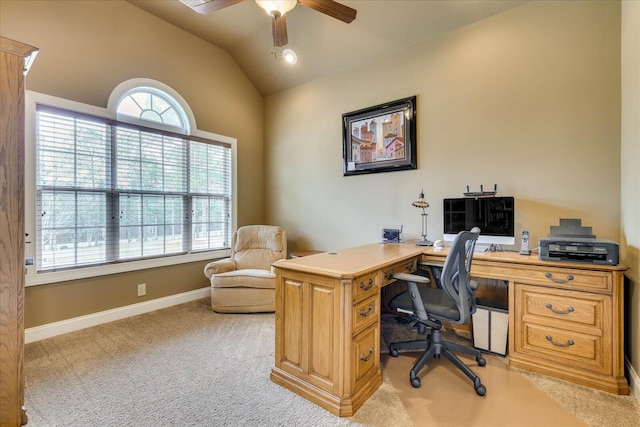 carpeted home office with vaulted ceiling, a healthy amount of sunlight, and ceiling fan