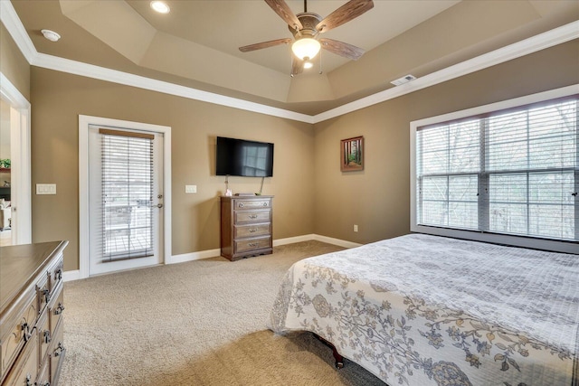 bedroom with ceiling fan, light colored carpet, a tray ceiling, and access to exterior