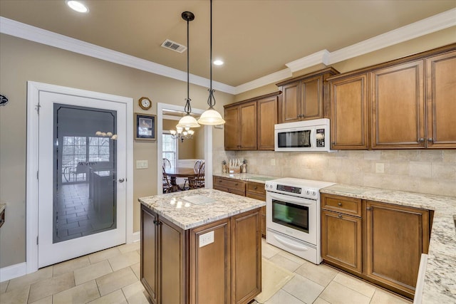 kitchen featuring light stone countertops, pendant lighting, electric range, and backsplash