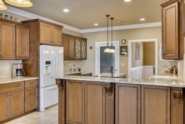 kitchen featuring crown molding, white fridge with ice dispenser, pendant lighting, and light stone counters