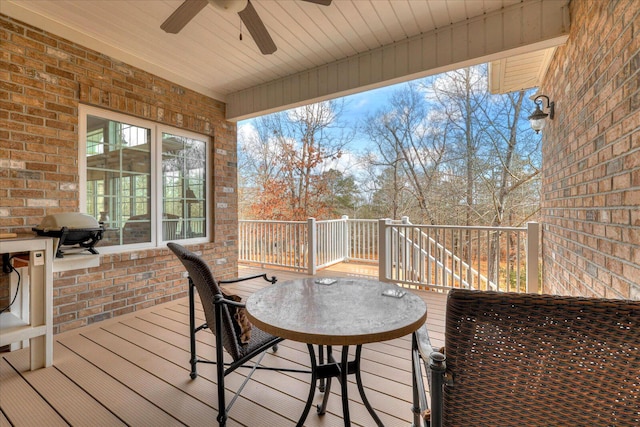 wooden deck featuring ceiling fan and area for grilling