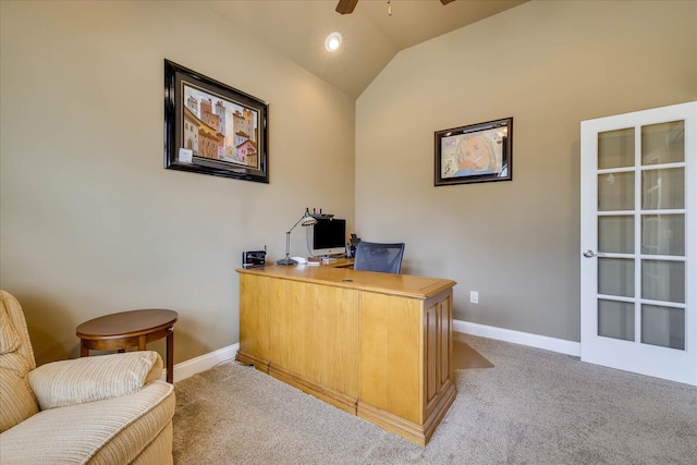 office space featuring vaulted ceiling, light colored carpet, and ceiling fan