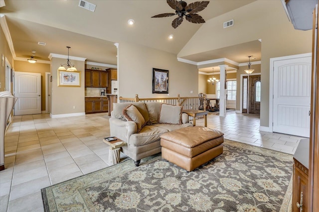 tiled living room featuring high vaulted ceiling, ceiling fan with notable chandelier, and ornamental molding