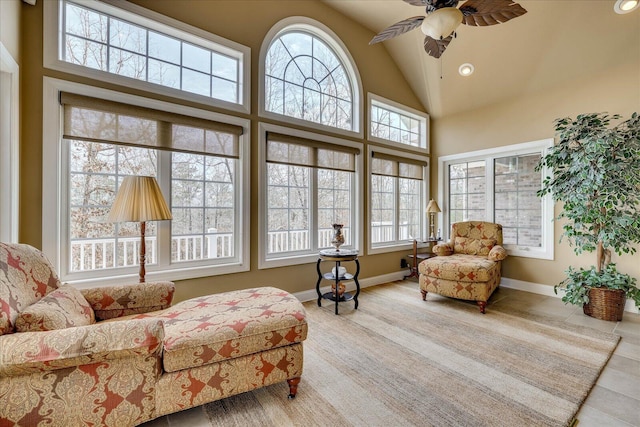 interior space featuring ceiling fan, high vaulted ceiling, and light tile patterned floors