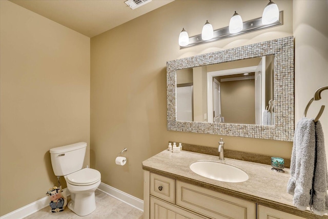 bathroom featuring tile patterned floors, vanity, and toilet