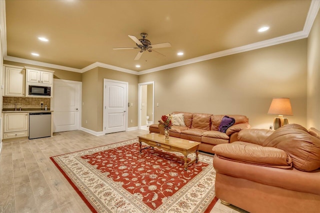 living room featuring ornamental molding, bar area, ceiling fan, and light hardwood / wood-style flooring