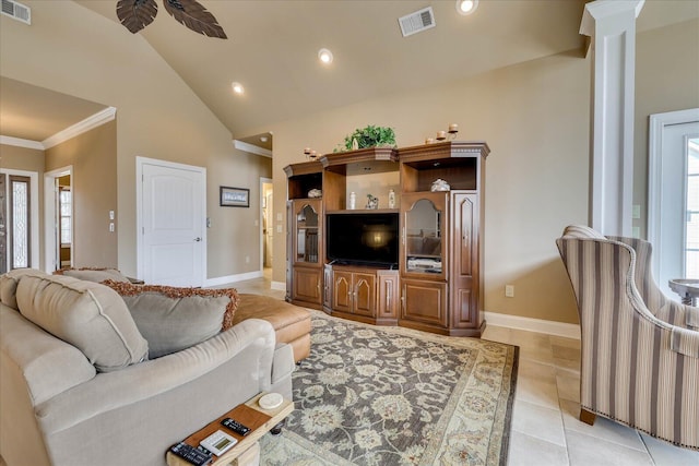 living room with light tile patterned floors, ornamental molding, decorative columns, and high vaulted ceiling