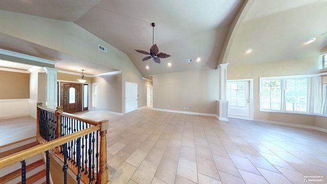 empty room featuring high vaulted ceiling, ornamental molding, ceiling fan, and ornate columns