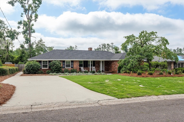 748 Mcclure Dr, Augusta, GA 30909 - single story home featuring brick siding, concrete driveway, a chimney, and a porch