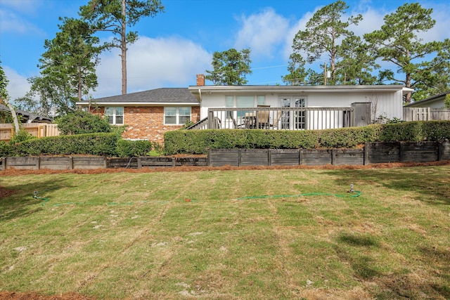 748 Mcclure Dr, Augusta, GA 30909 - back of property featuring a chimney, a wooden deck, and brick siding