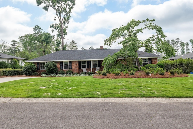 748 Mcclure Dr, Augusta, GA 30909 - single story home with brick siding, a front yard, a chimney, and driveway