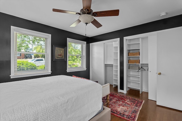 748 Mcclure Dr, Augusta, GA 30909 - bedroom featuring multiple closets, wood finished floors, and a ceiling fan