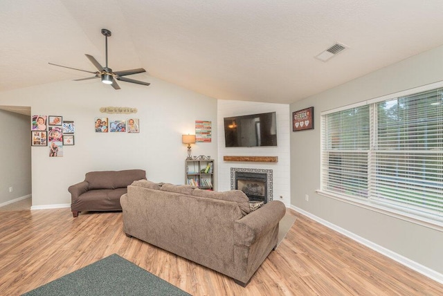 510 Sweet Meadow Dr, Grovetown, GA 30813 - living room with vaulted ceiling, light wood-type flooring, a ceiling fan, a fireplace, and baseboards