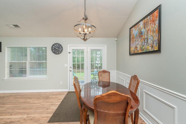 510 Sweet Meadow Dr, Grovetown, GA 30813 - dining area featuring a chandelier, light wood-style floors, wainscoting, and a textured ceiling