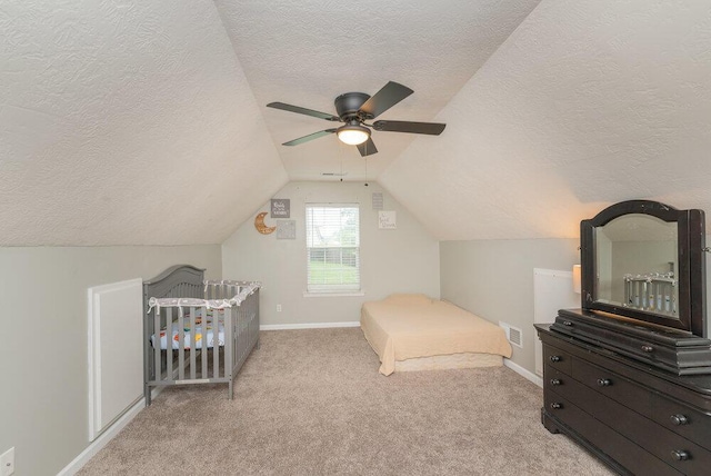 510 Sweet Meadow Dr, Grovetown, GA 30813 - bedroom featuring a textured ceiling, light carpet, vaulted ceiling, baseboards, and ceiling fan