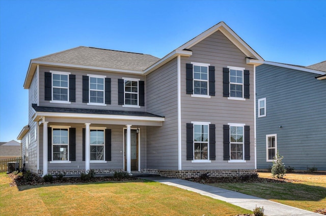 traditional home with central air condition unit, covered porch, a front lawn, and roof with shingles