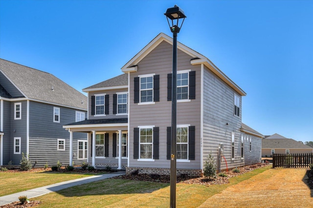 view of front of house featuring a front yard and fence