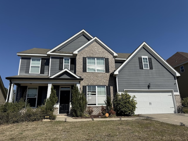 craftsman-style house with a garage, concrete driveway, and brick siding