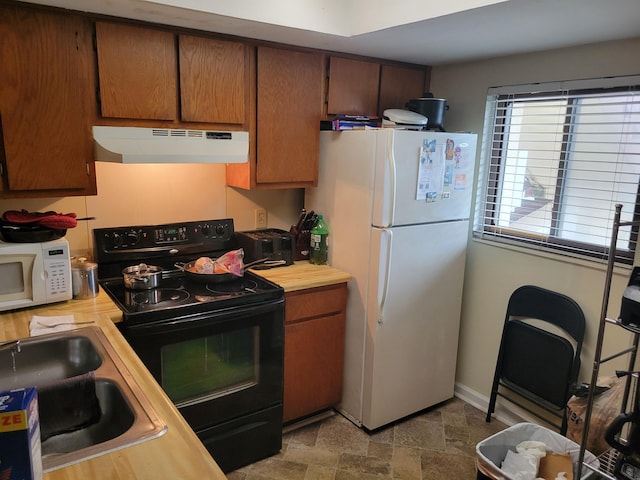 1001 Windsong Cir, Augusta, GA 30907 - kitchen featuring white appliances, under cabinet range hood, a sink, butcher block counters, and stone finish floors