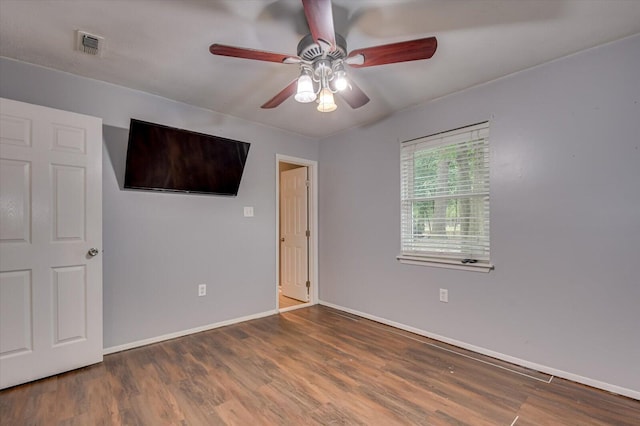 unfurnished bedroom featuring dark hardwood / wood-style flooring and ceiling fan