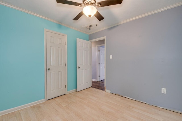 unfurnished bedroom featuring ceiling fan, light wood-type flooring, and ornamental molding