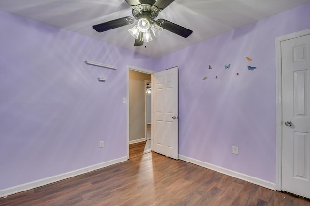 unfurnished bedroom featuring ceiling fan and dark wood-type flooring