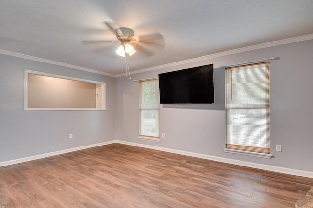 unfurnished room featuring ceiling fan, hardwood / wood-style floors, and ornamental molding