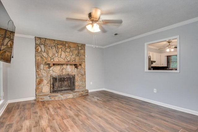 unfurnished living room featuring a stone fireplace, ceiling fan, hardwood / wood-style floors, and ornamental molding