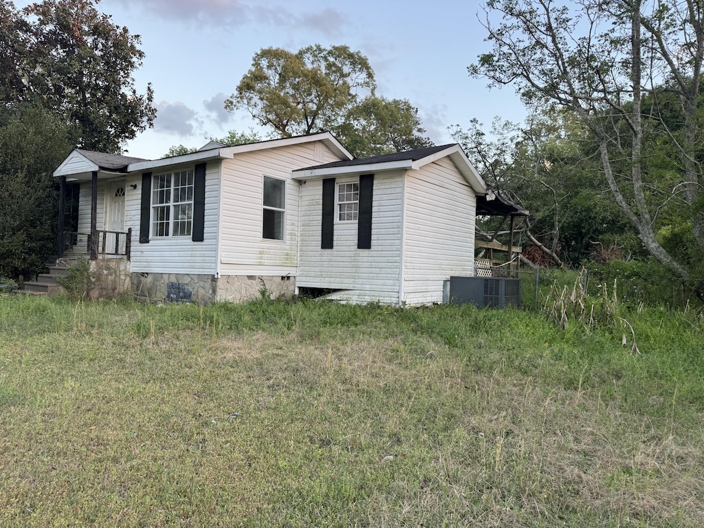 view of side of home with central AC
