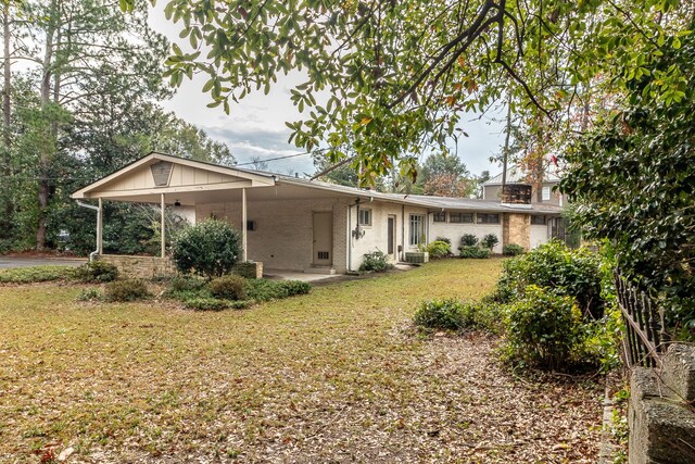 rear view of house featuring a yard