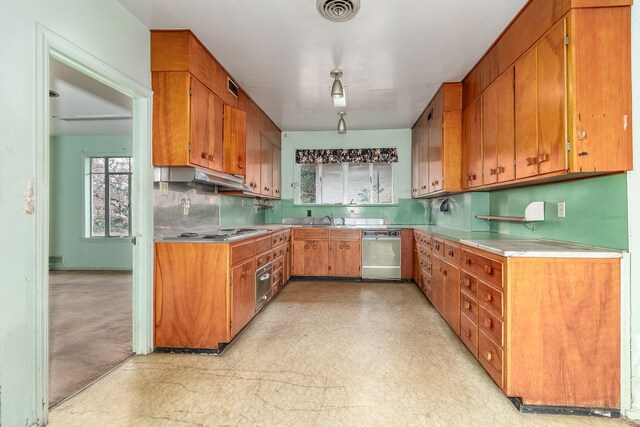 kitchen with decorative backsplash, sink, and stainless steel appliances