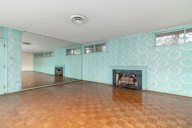 basement featuring a fireplace and light parquet flooring