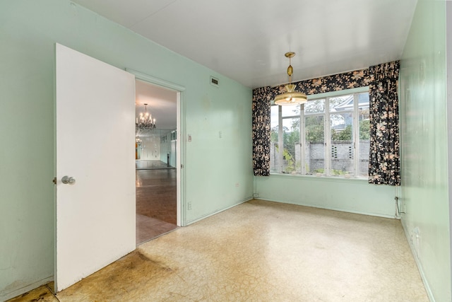 empty room featuring a notable chandelier