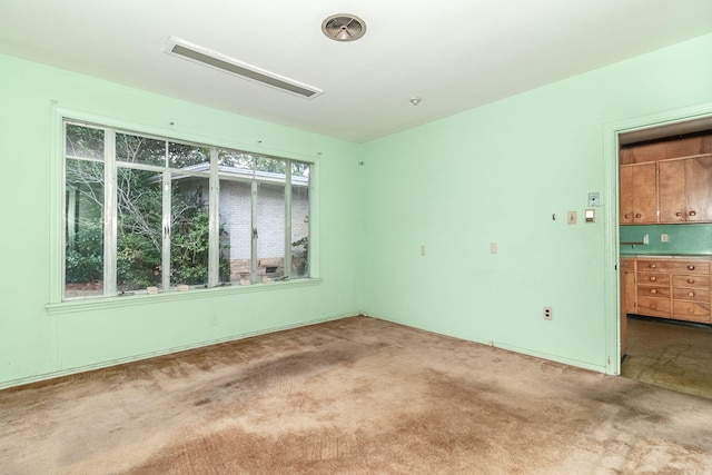 spare room with carpet floors and a healthy amount of sunlight