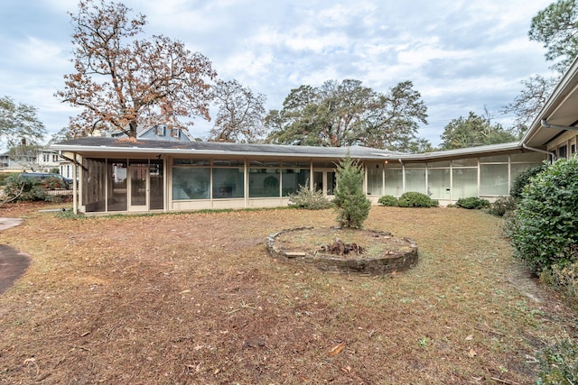 back of property with a sunroom