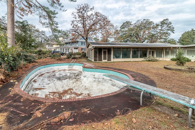 view of swimming pool with a sunroom